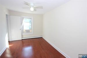 Room with cherry wood floors and ceiling fan