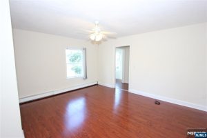 Room with red wood floors and side window