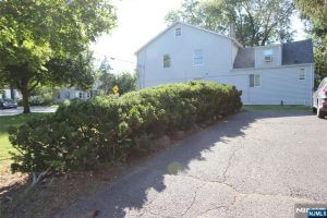 Side driveway and yard of a white house