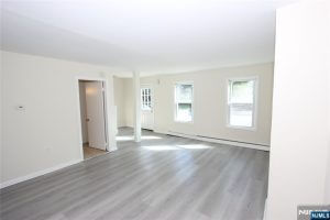 Open room with gray floors and doorways