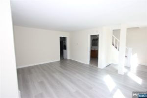 Bright empty room with gray plank floors