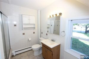 Bathroom with wood vanity and mirror cabinet